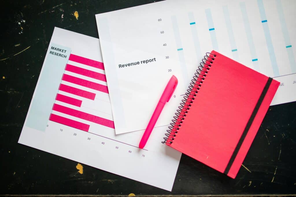 A notebook with graphs and a pen on the best platform to sell online courses' table.